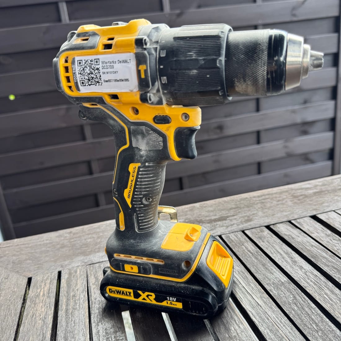 Worker scanning QR code on drill with phone - Toolero tool tracking system